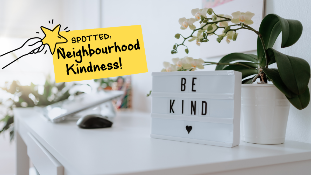 Desk with sign that reads be kind. Text on top reads spotted, neighbourhood kindness. 
