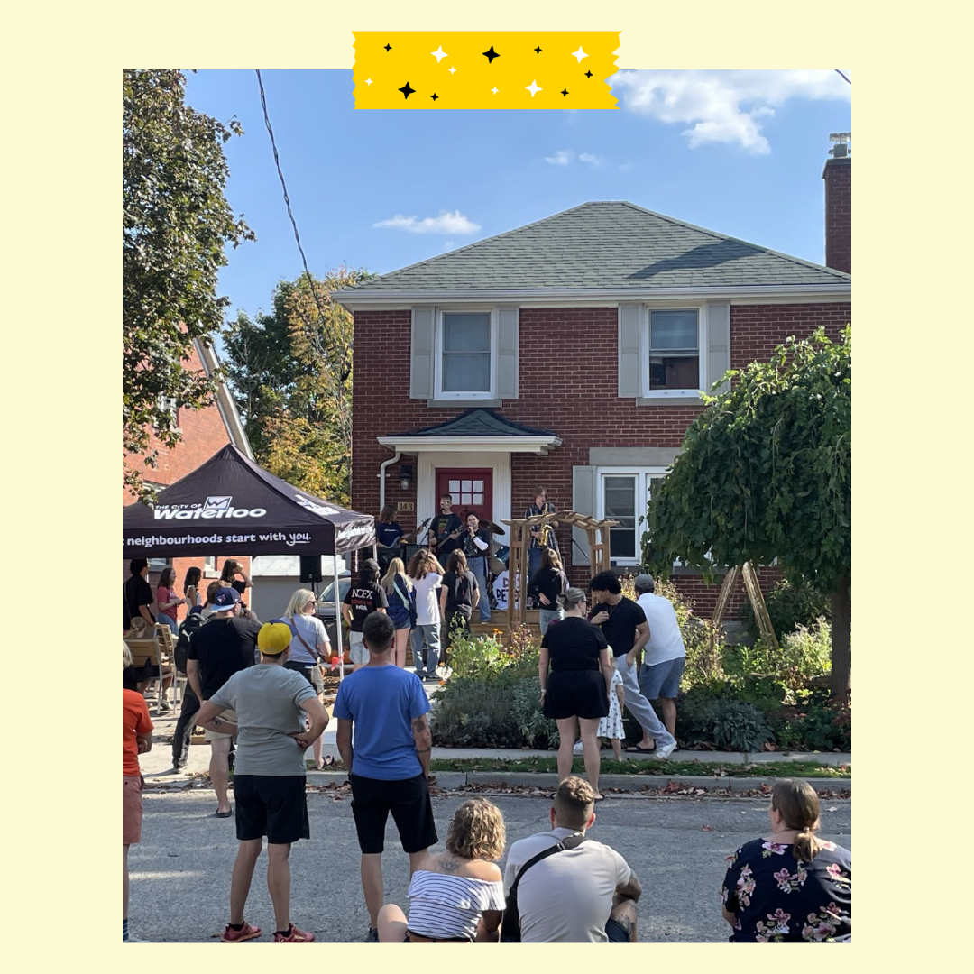 People outside on a porch planning music and other people on a street listening to it.