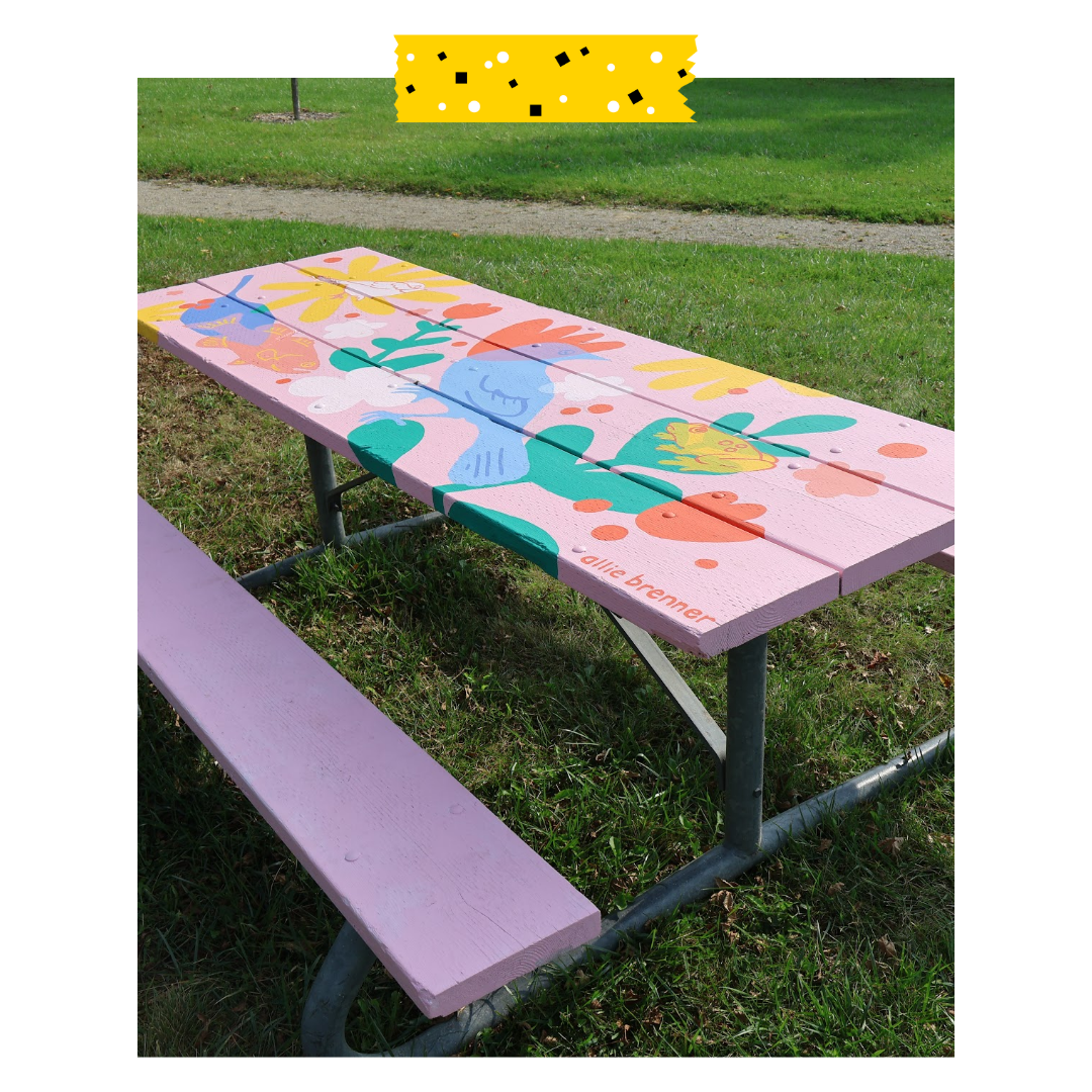 Pink picnic table with art design on it.