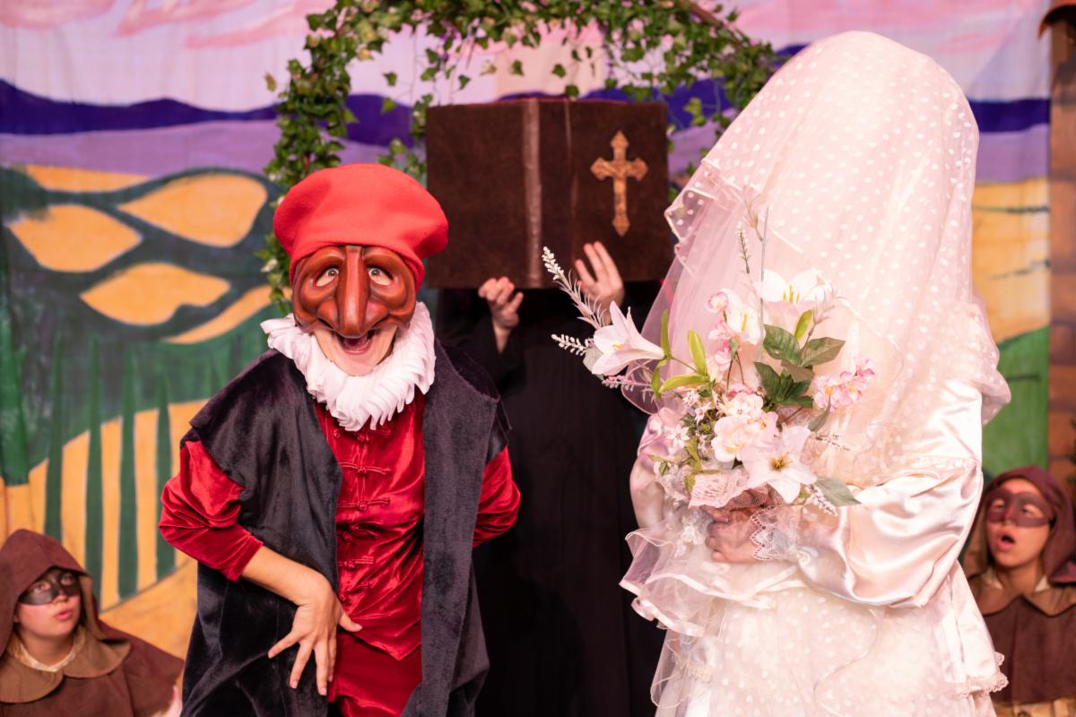 two characters from the play in a wedding scene