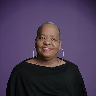 head shot of Professor Kendra Frorup with a purple background