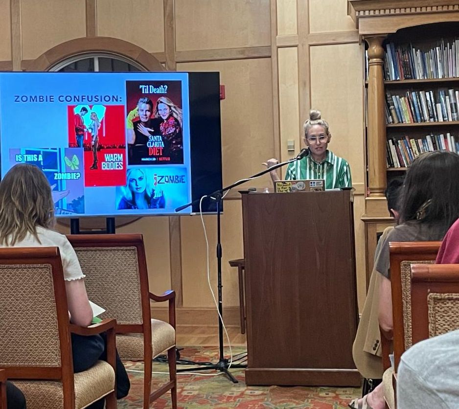 Dr. Sarah Juliet Lauro behind a podium presenting