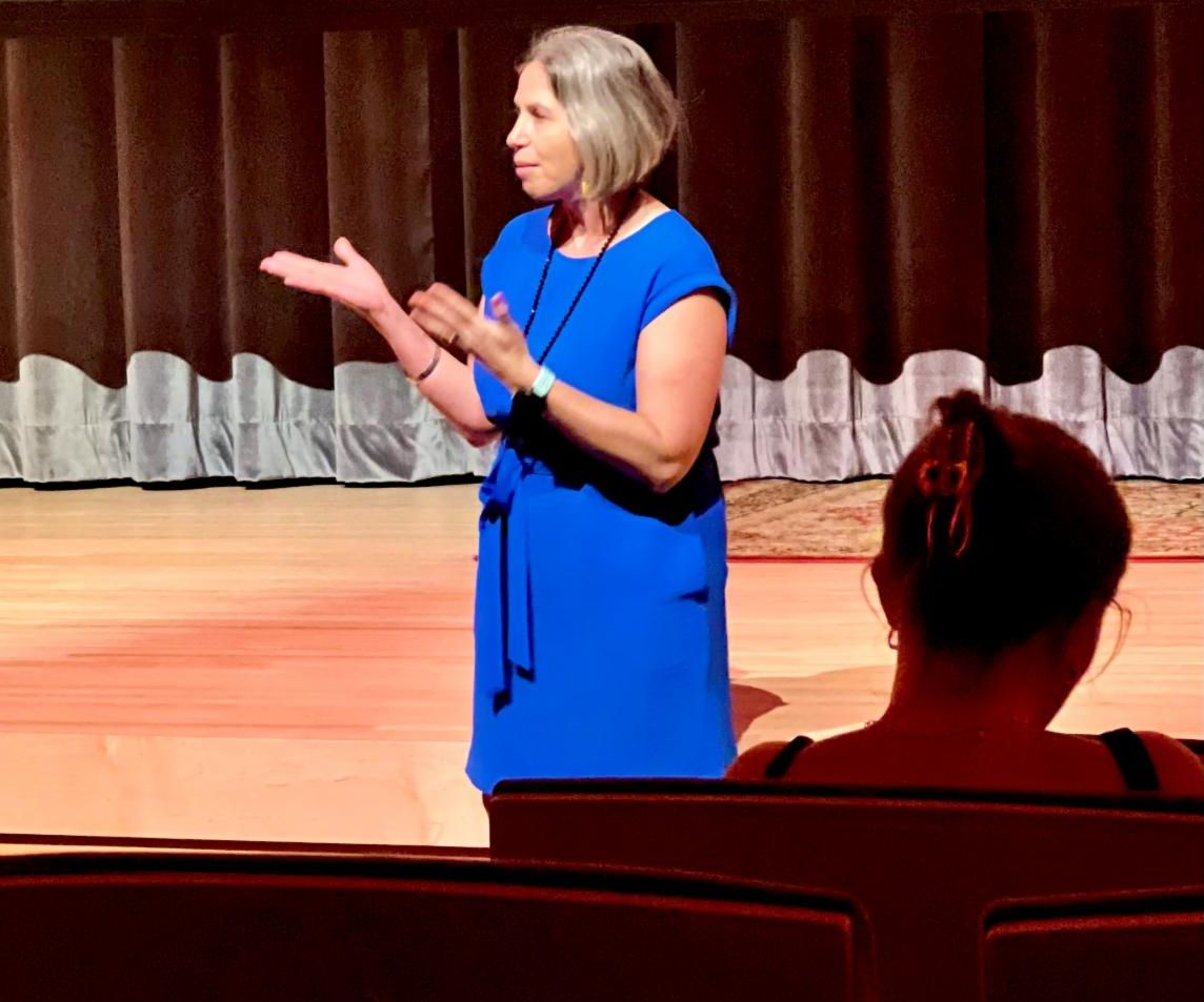 photo of Dr. Vanessa Rukholm in the Gordon Theatre introducing a French film