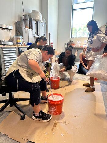 Professor Frorup's students creating sculpture out of surgical waste