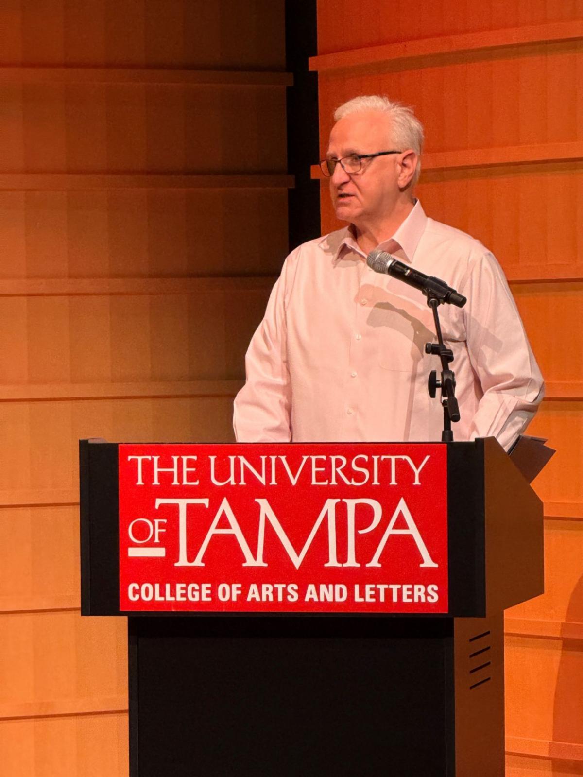 Mark speaking at the podium