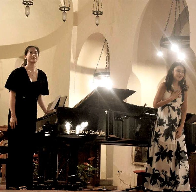 two females by a piano