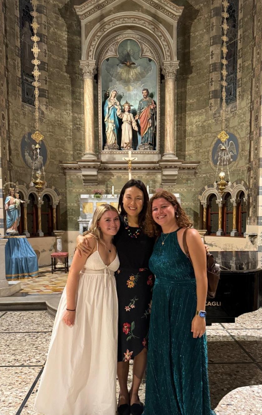 Two students pictured with Dr. Jung in a chapel in Italy