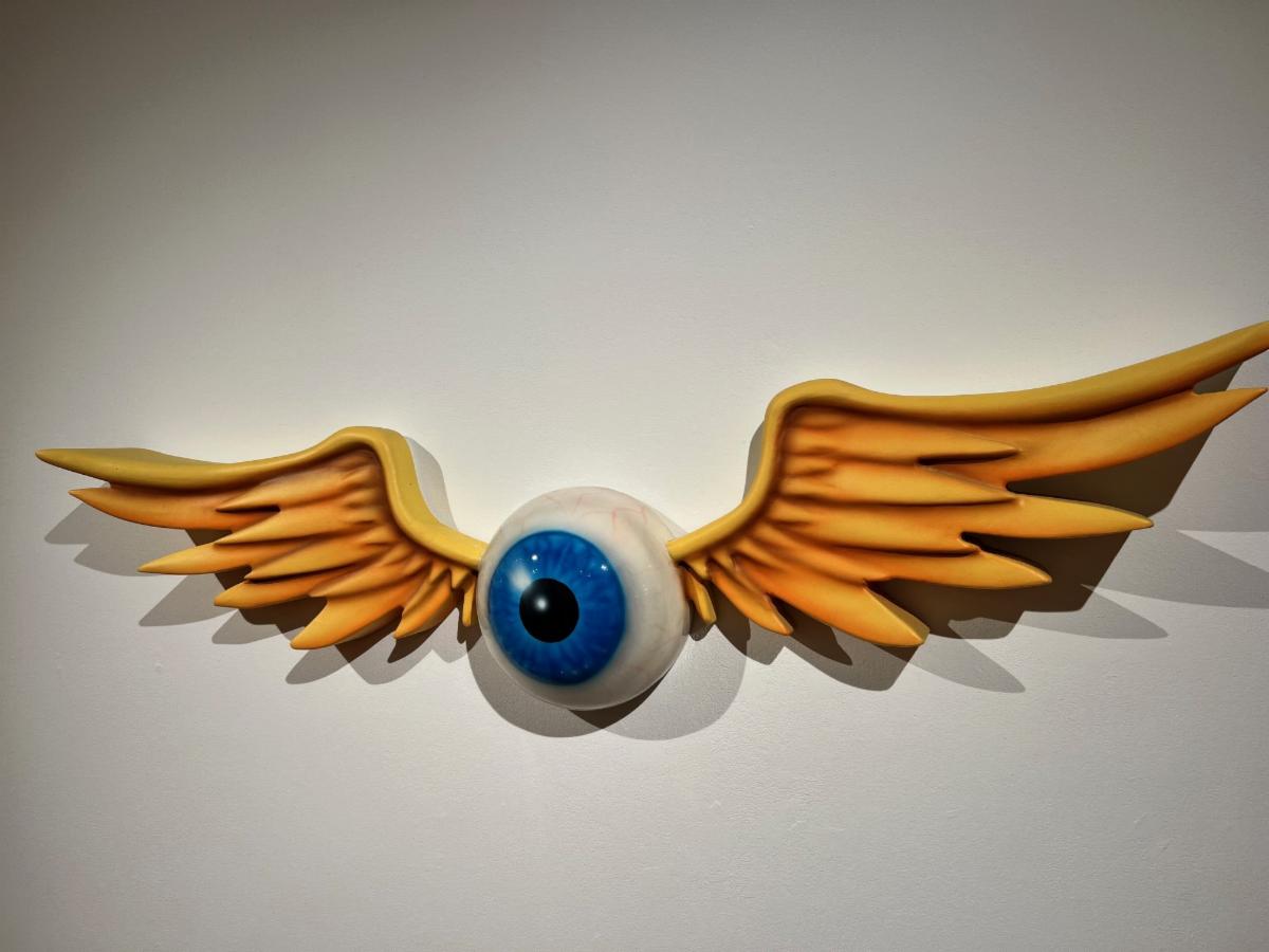 sculpture of an eye ball with wings