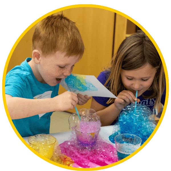Young boy and girl making art and laughing.