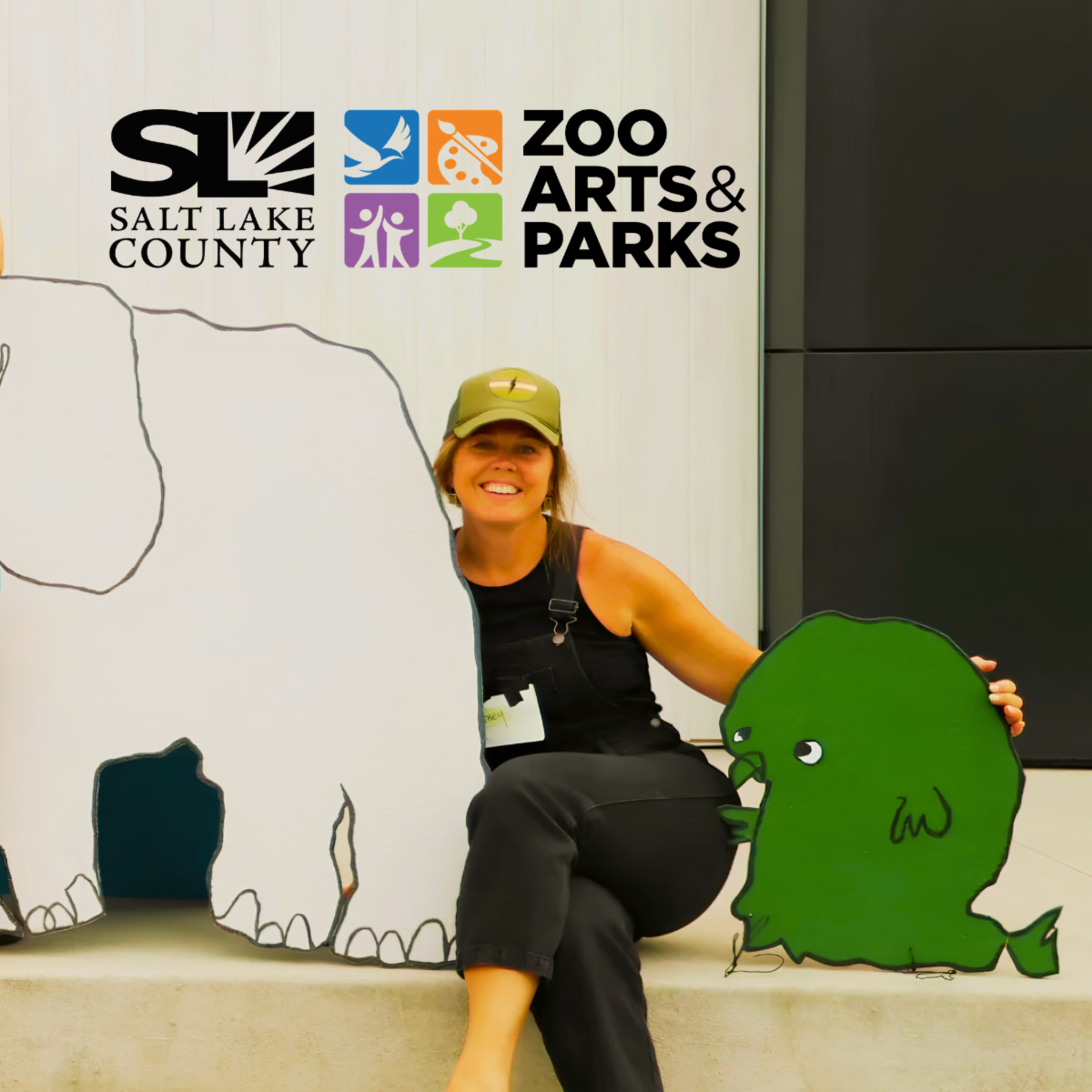 Woman sitting between two art sculptures