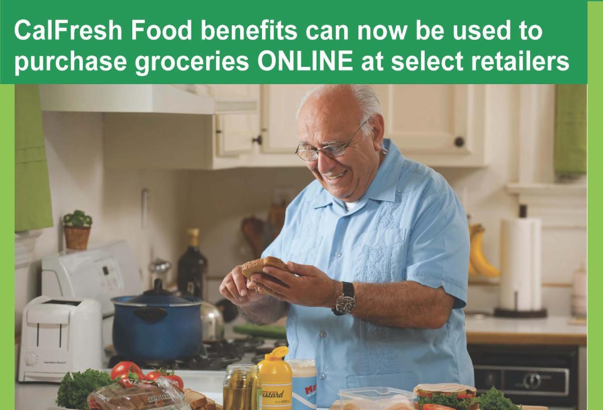 Flyer advertising that CalFresh Food benefits can now be used to purchase groceries online at select retailers. photo of a man in his kitchen holding bread and a knife making a sandwich.