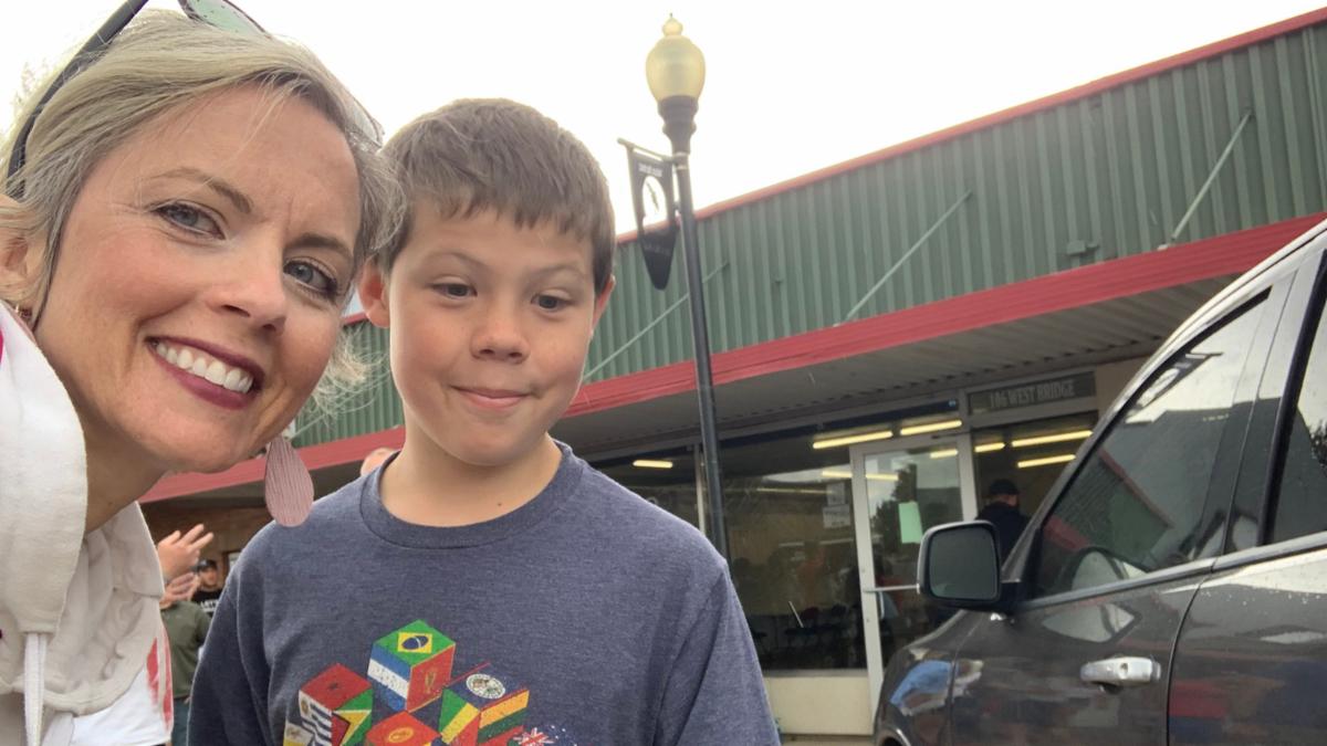Sarah and Jake pose for a selfie in front of a store