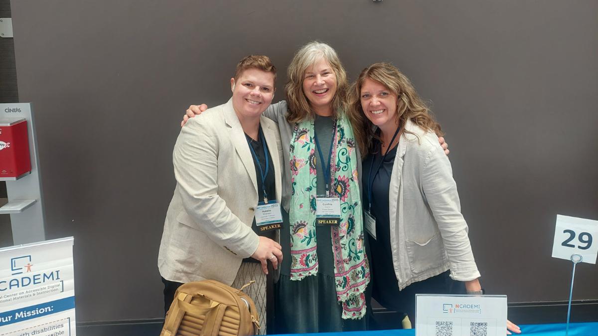 group portrait of three women behind the NCADEMI conference table