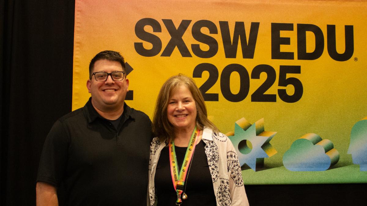 Cynthia and a friend in front of the SXSW EDU banner