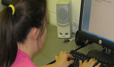 Young woman typing at a computer