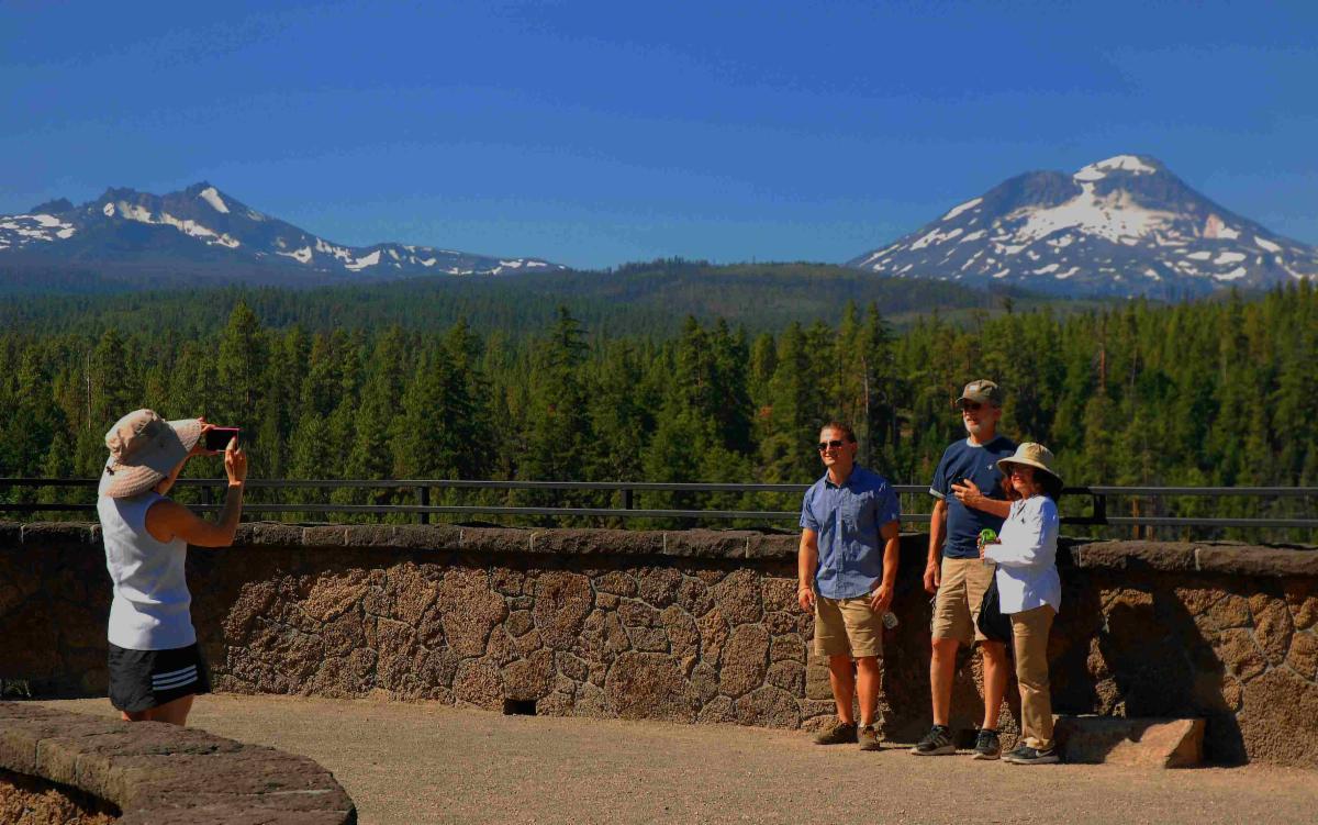 A group of people poses for a photo at a scenic overlook.