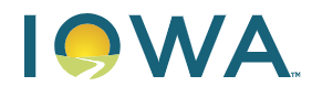 The logo of the Iowa Department of the Blind. The letters IOWA are all capitals in dark blue. The center of the letter O includes a white path through a green landscape leading towards a yellow sun.