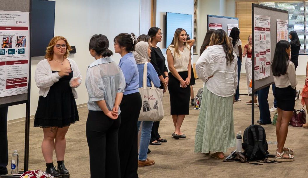 Students present their summer research posters to community members