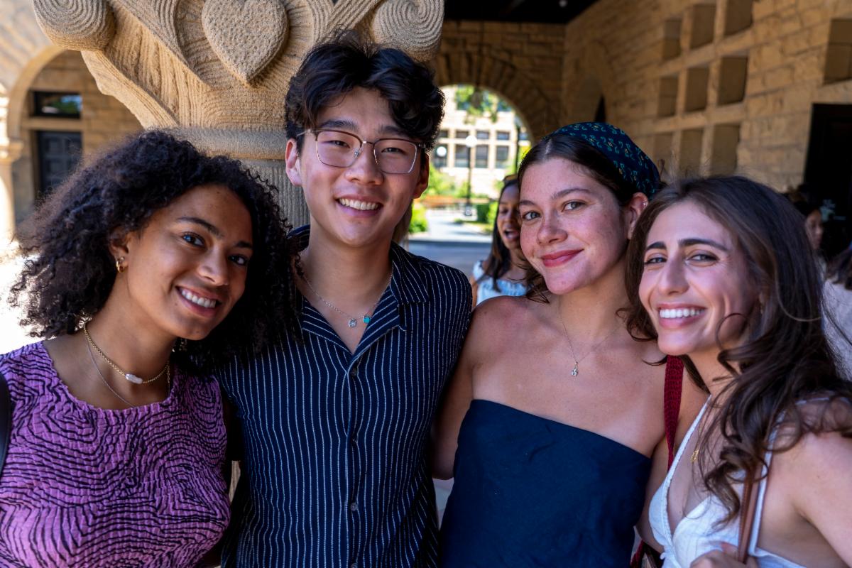 Four students smiling at celebration