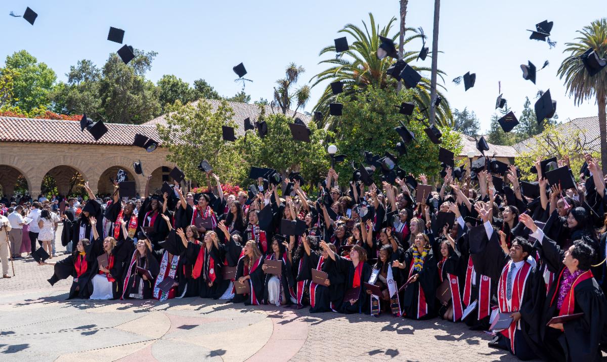 Class of 2025 throw their caps in the air in the Main Quad