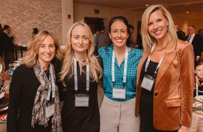 Four attendees together at the Boston CEO cocktail reception