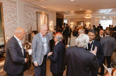 Attendees talking over drinks at the Boston CEO cocktail reception