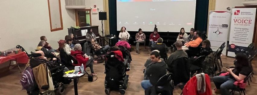 A photo of people gathered in an event room for a Pajama Party Politics event.