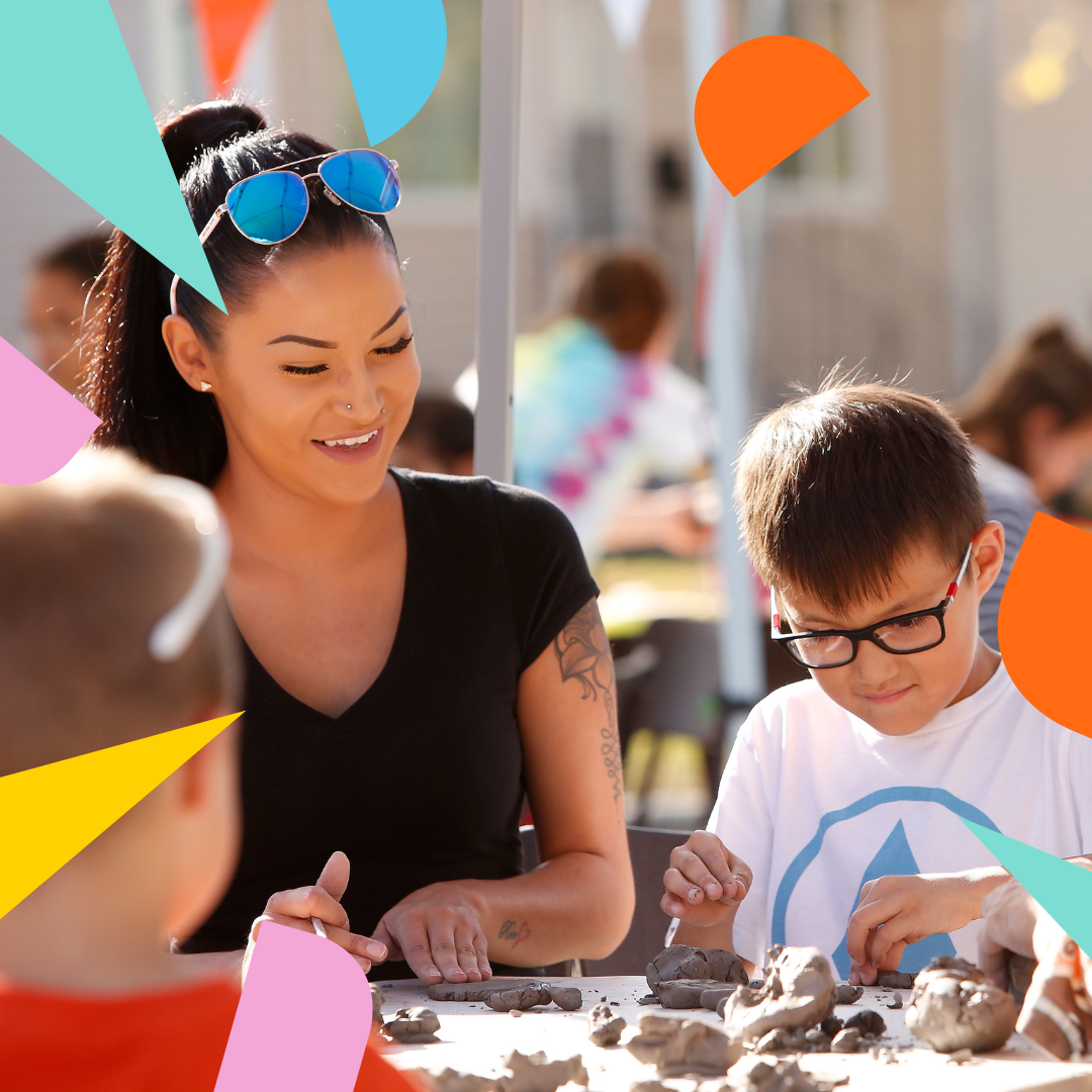 A photo of an adult and a kid making art with clay at a Culture Days event.