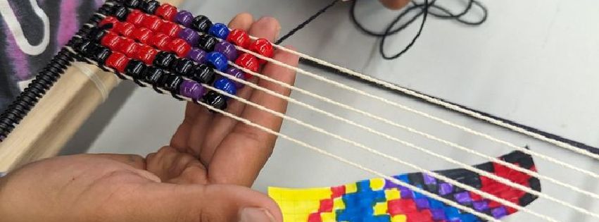 A close-up photo of someone beading.