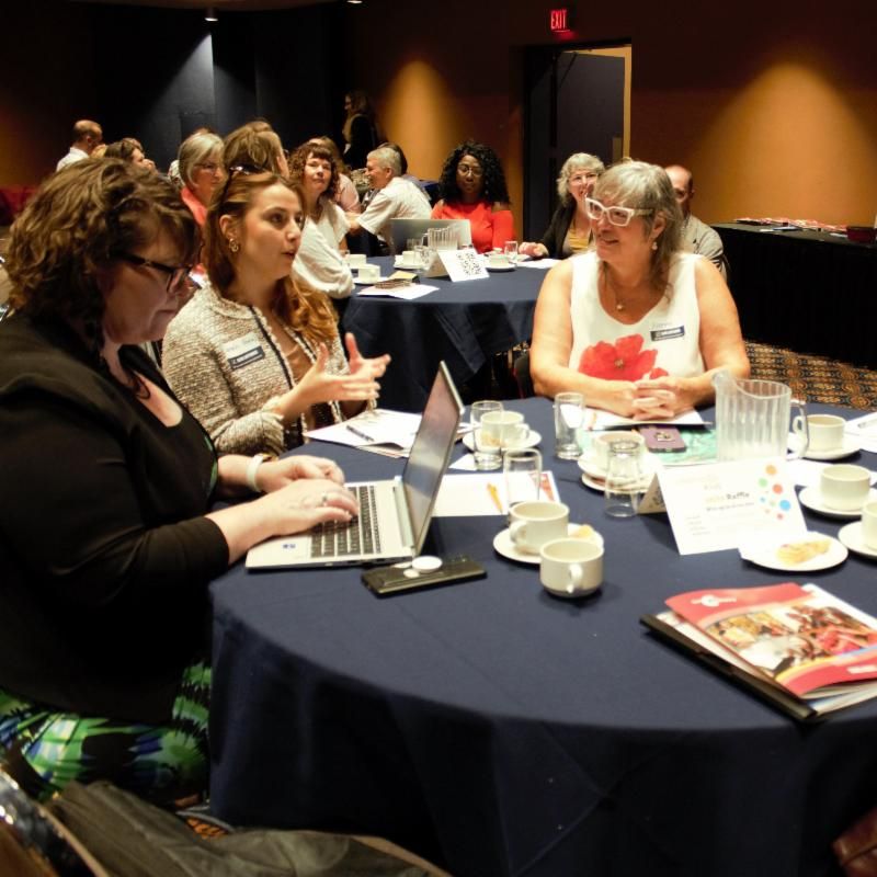 A photo of staff from SaskCulture member organizations talking at the 2023 AGM.