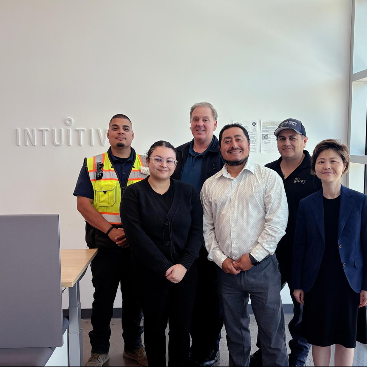 The Community Development Department Building Division standing in front of the Intuitive Sign