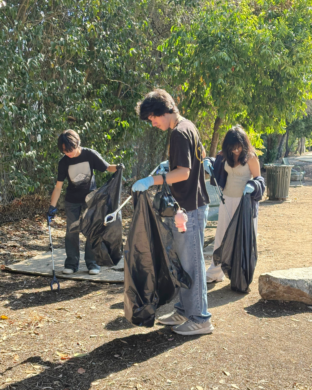 volunteers picking up trash at San Ysidro Park