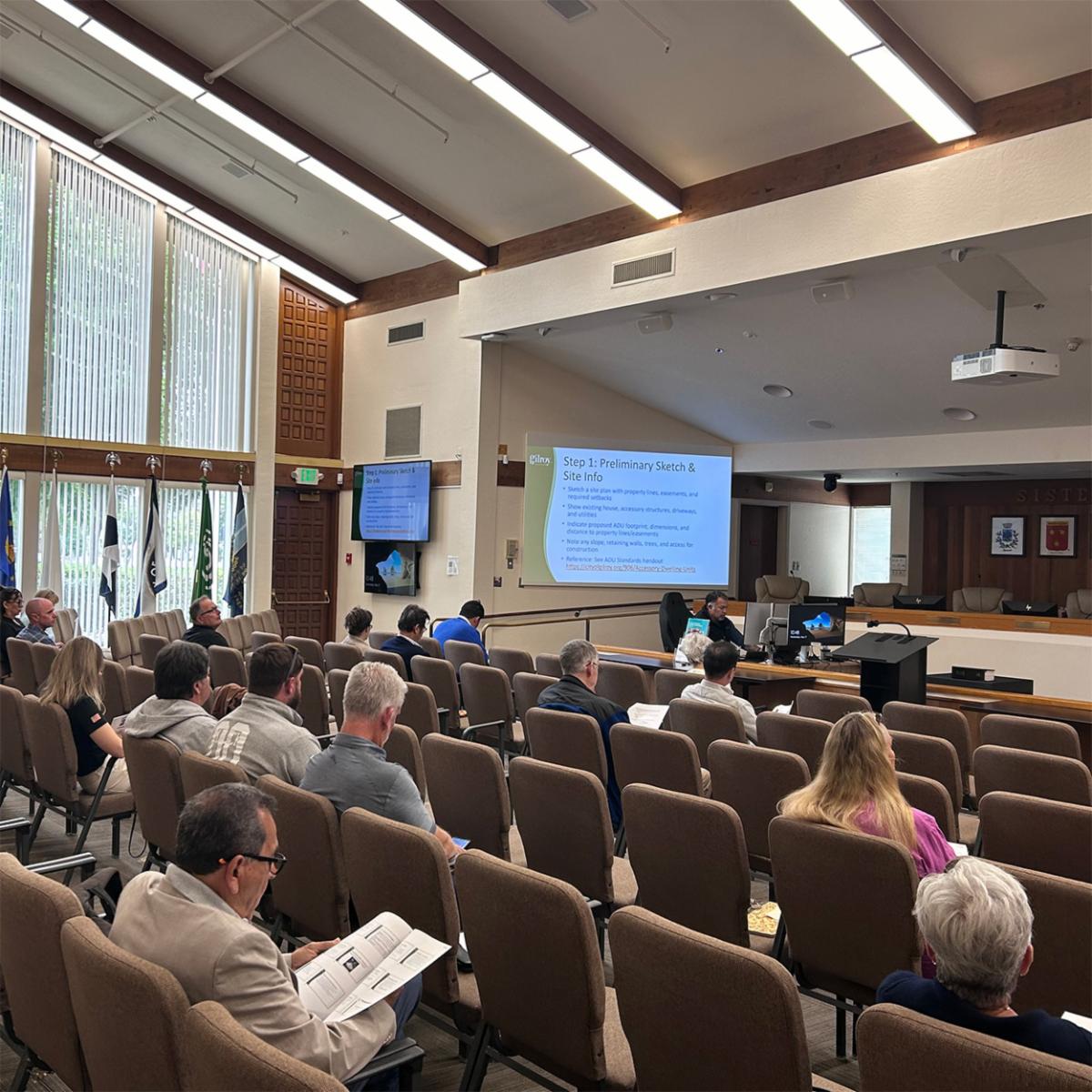 group of individuals looking at a presentation during a meeting