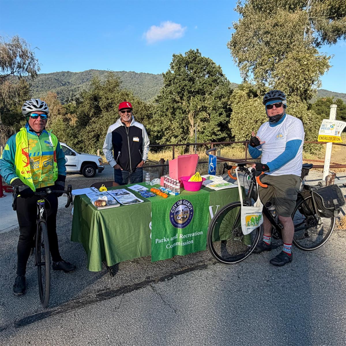 Two bicyclists standing with their bikes next to the energizer station