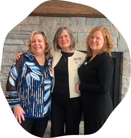 three women with their arms around each other