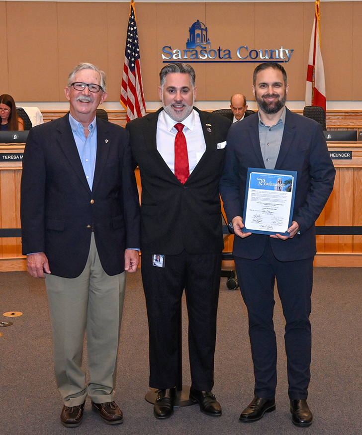Photo of people standing in commission chambers for the Flood Awareness Week proclamation. 