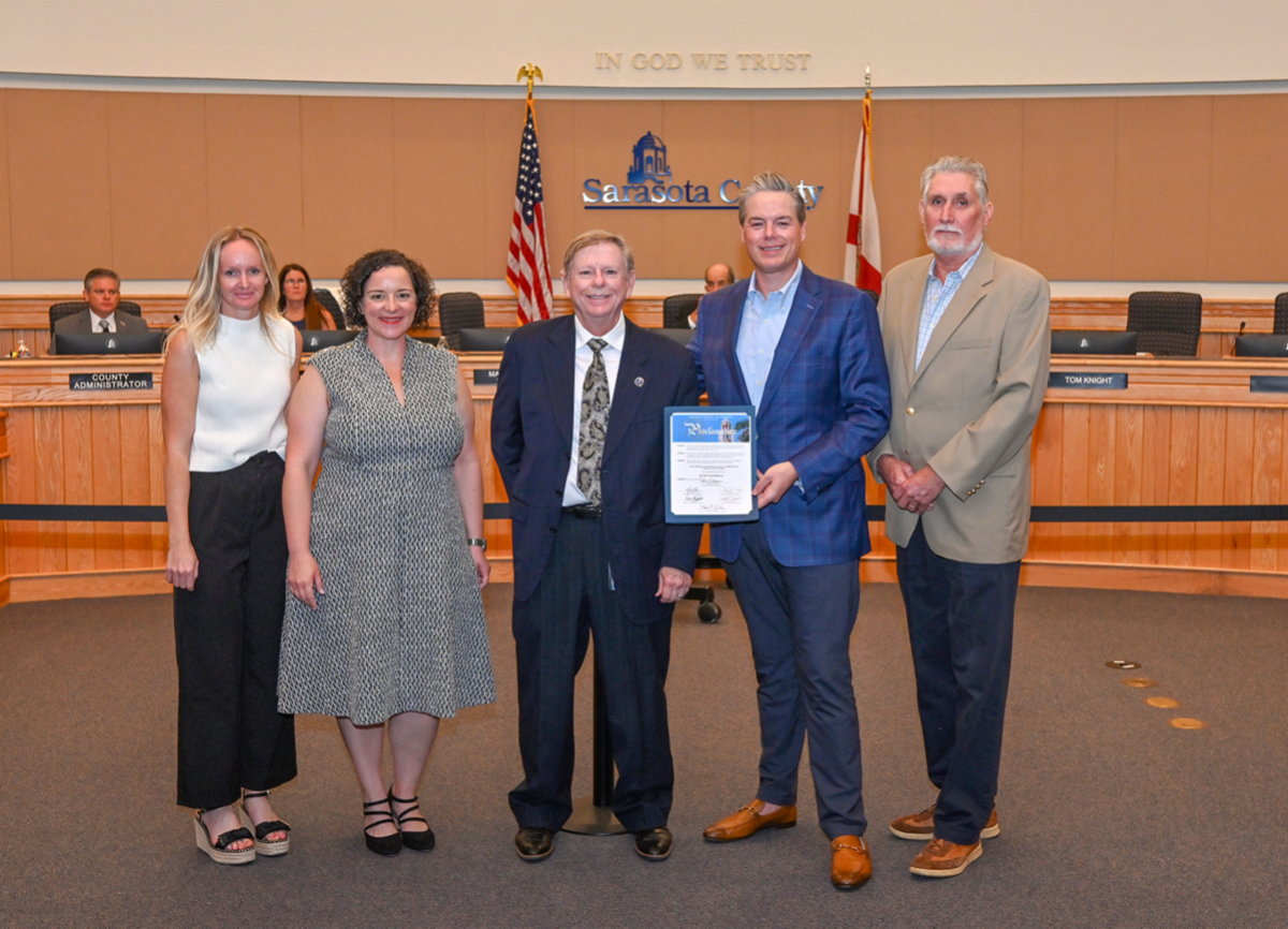 Photo of people standing in commission chambers for the Better Together proclamation. 