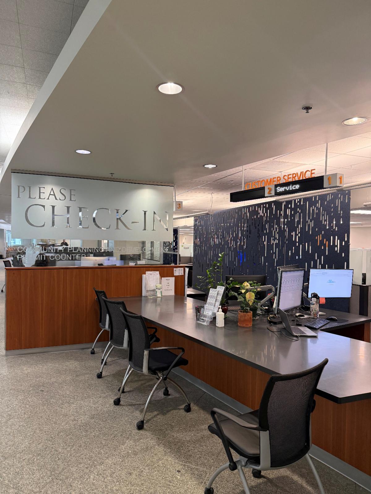 Photo of desks and cubes in entrance of Denver Permit office