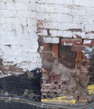 Photo of painted brick crumbling
