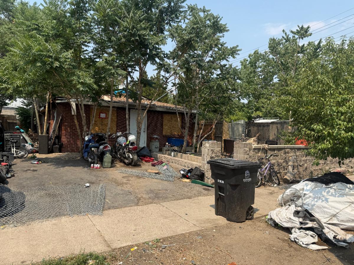 a house with debris and garbage in front of it