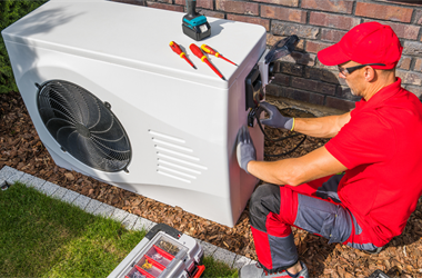 person installing a heat pump