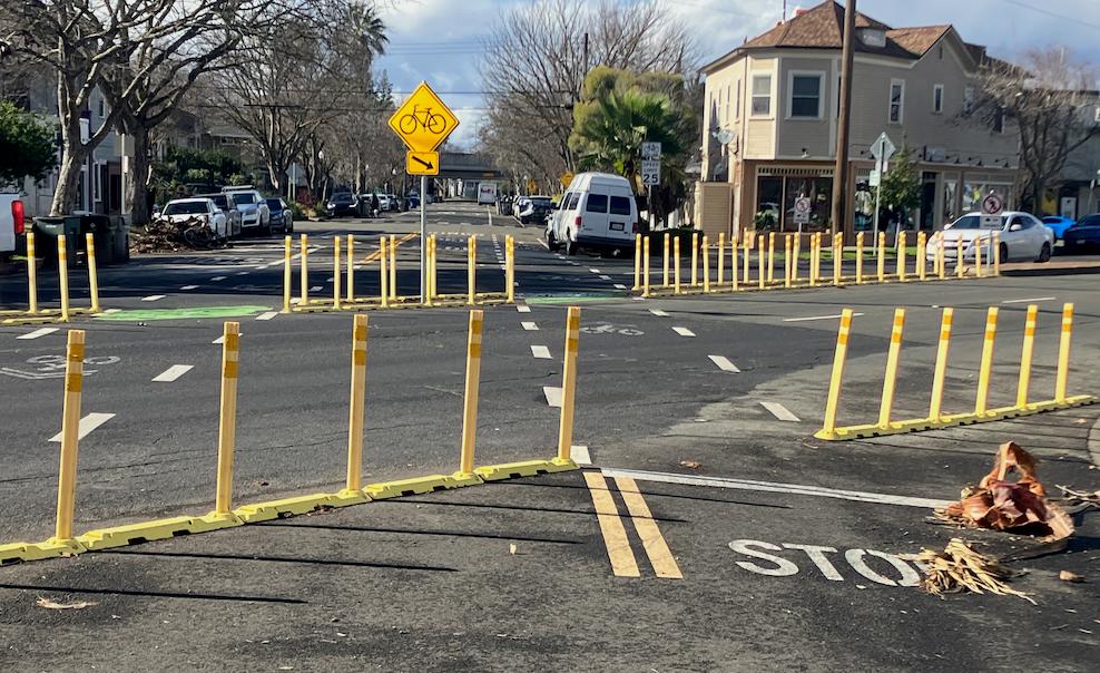 Intersection with marked bike path and barriers.