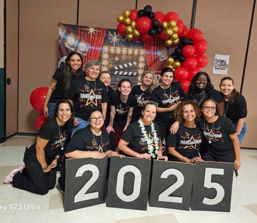 A photo of the 2024-2025 PTSA posing in front of decorations at the 8th grade formal.