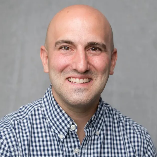 michael smiling wearing checkered dress shirt