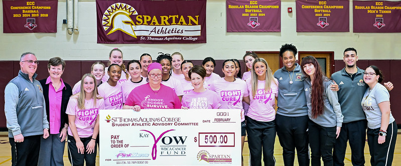 Check Presentation for Breast Cancer Awareness with Womens basketball team