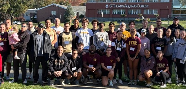 cross country alumni and friends posing for group photo