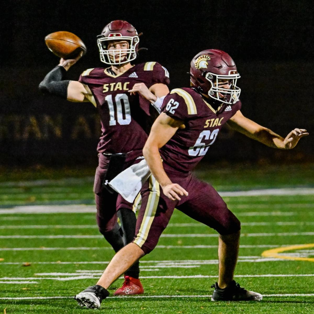 Ryan Kenny throwing football on field during game