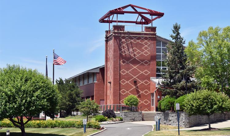 Costello Hall flag with blue sky in background