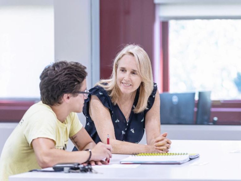 Career Center staff member and student in open concept office lobby area