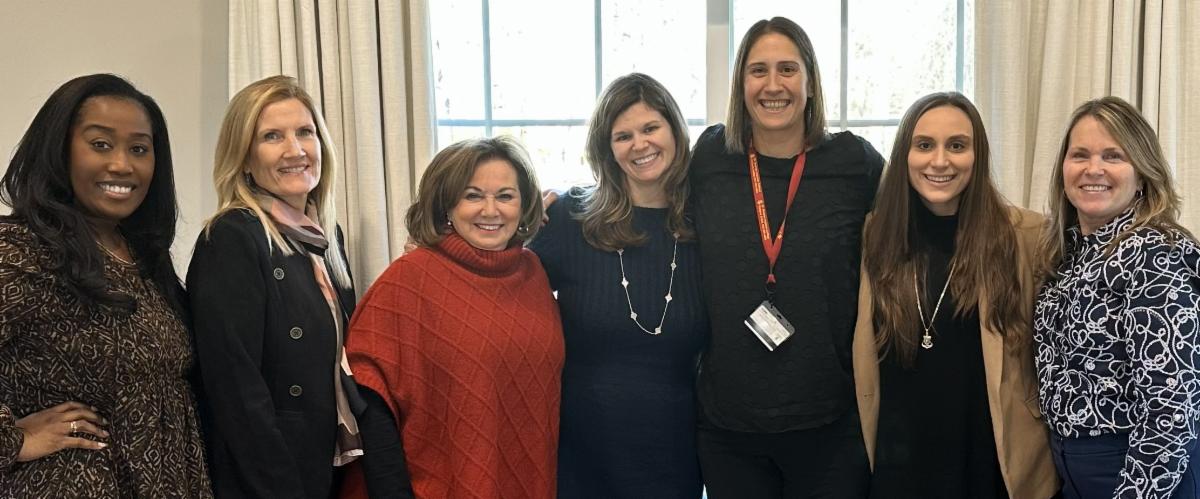 seven womens leadership group smiling